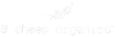 White logo with a simple line drawing of a leafy branch above the words “8 sheep organics” in lowercase letters. The text and branch are on a plain white background.