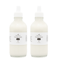 Two clear glass dropper bottles filled with a white liquid, each labeled True Blue Yarrow and featuring a simple black illustration of a yarrow plant on a white background.