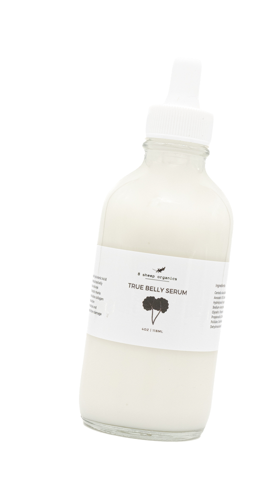 A glass bottle labeled True Belly Serum with a white liquid inside and a dropper cap, photographed against a white background.
